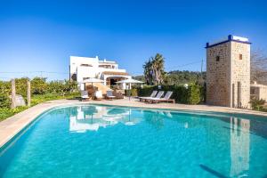 a large swimming pool in front of a house at Villa Musset in Can Furnet