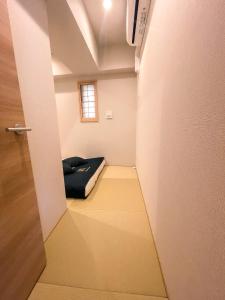 a small room with a bed and a door at Shinkou House UE - Newly Built Secure and Hypoallergenic in Osaka +62 photos