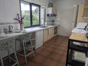 een keuken met een aanrecht, een wastafel en een raam bij LA RAIGADA Maravilloso chalet a pie de playa in Ribadesella +34 foto's