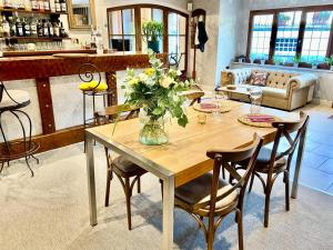 ミュラにあるHôtel Restaurant du Plomb du Cantalの花瓶付きのダイニングテーブル
