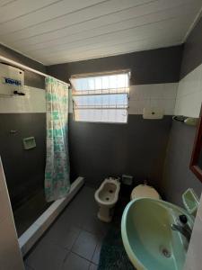 查斯科穆斯Casa a dos cuadras de la laguna的带水槽、马桶和淋浴的浴室