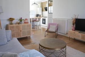 a living room with a couch and a table at La Marie-Louise in Brive-la-Gaillarde