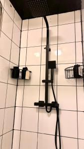 a room with three lights on a white tiled wall at Kingston Studio, ideal for professionals relocators and leisure stays, near Kingston Station and Shopping Centre in Kingston upon Thames