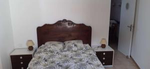 a bedroom with a bed with two nightstands and two lamps at AS22244- P4 Vue Mer, sur la plage à 2 pas du Centre Ville avec parking privé in Le Grau-du-Roi +3 photos