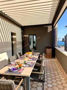 a dining room with a long table and chairs at Villa AYA in Riposto