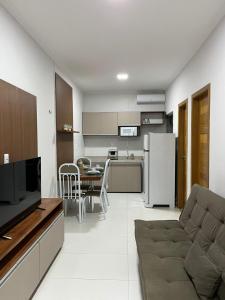 a kitchen and living room with a couch and a table at STILLO AÇAI in Bragança