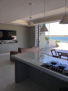 a kitchen with a counter and a stove top oven at Apartamento Lagoa do Paraiso - Jericoacoara in Jijoca de Jericoacoara