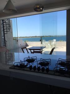 a kitchen with a stove with a view of a patio at Apartamento Lagoa do Paraiso - Jericoacoara in Jijoca de Jericoacoara