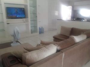 a living room with a couch and a flat screen tv at Casa dos Maias in Valença