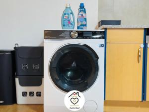 a washing machine in a kitchen next to a counter at Family M Apartments 2 in Kappel bei Olten +16 photos