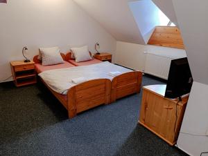 a bedroom with two beds and a tv in it at Hotel Esprit in Špindlerův Mlýn +47 photos