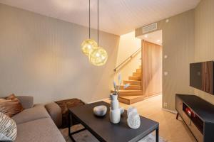 a living room with a couch and a table at DINBNB Apartments 800m to Oslo C Station l 133sqm l High-End in Oslo