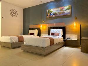 Postel nebo postele na pokoji v ubytování Le Prestige Residency