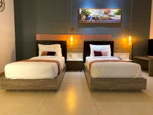 Postel nebo postele na pokoji v ubytování Le Prestige Residency