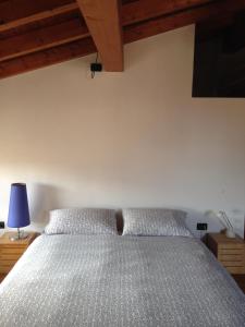 a bedroom with a bed and a blue lamp at La Corte del Noce in Zanica