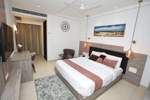 Postel nebo postele na pokoji v ubytování Le Prestige Residency