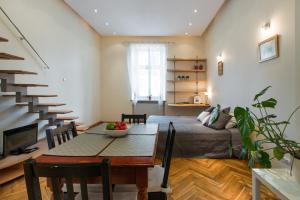 a living room with a table and a bed at Urban Studio Apartment in Krakow