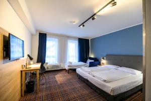 Postel nebo postele na pokoji v ubytování Hotel Ambassador Essen