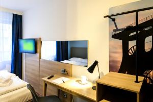 TV a/nebo společenská místnost v ubytování Hotel Ambassador Essen