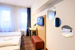 Postel nebo postele na pokoji v ubytování Hotel Ambassador Essen