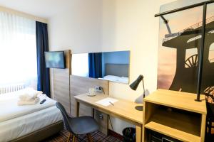 Postel nebo postele na pokoji v ubytování Hotel Ambassador Essen