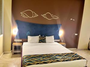 Postel nebo postele na pokoji v ubytování Aryana Queen Beach Resort