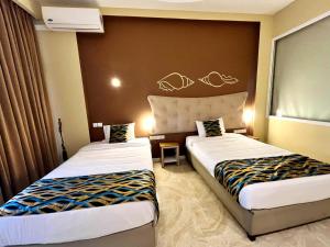 Postel nebo postele na pokoji v ubytování Aryana Queen Beach Resort