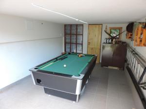 a pool table in a living room with at Chata Dáša in Poráč