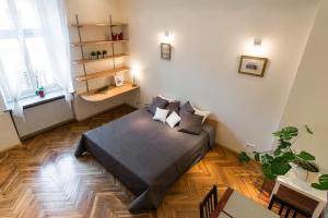 a bedroom with a bed in the middle of a room at Urban Studio Apartment in Krakow