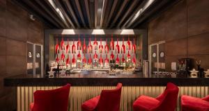 a bar with red chairs in front of it at Best Western Plus Plaza Hotel Darmstadt in Darmstadt +119 photos