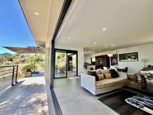 a living room with a couch and a table at Villa d'architecte avec vue mer imprenable in Viggianello +12 photos