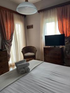 a bedroom with a bed and a flat screen tv at Rachel in Nisís Áyios Nikólaos