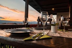 a table with glasses and plates and utensils on at Гусу Баба in Kostenets