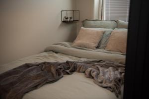 a bed with a blanket on it in a room at Penthouse, heart of city center, high standard in Stavanger