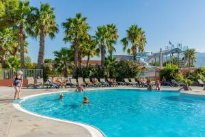 a group of people in a swimming pool at a resort at Résidence Antinéa in Argelès-sur-Mer