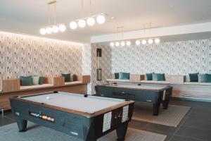 a room with two pool tables and couches at BANCAL HOTEL and SPA in San Sebastián de la Gomera