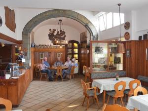 a group of people sitting at tables in a restaurant at Hotel Felsenkeller in Idstein