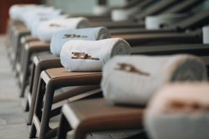 a row of white towels sitting on a bench at BANCAL HOTEL and SPA in San Sebastián de la Gomera