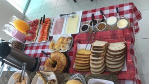 a table with a bunch of sandwiches and other food at Pousada Souza & Souza in Barra Velha