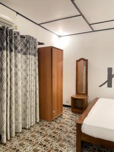 Postel nebo postele na pokoji v ubytování Dew Ceylon Villa