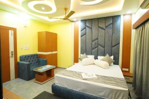 a hotel room with a bed and a chair at Goa Beach Resort ON Beach in Mandarmoni