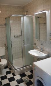 a bathroom with a shower and a sink and a toilet at Rab From Above Studio Apartment in Rab +17 photos