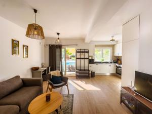 a living room with a couch and a table at Beach Villa Playa Flamenca in Orihuela Costa