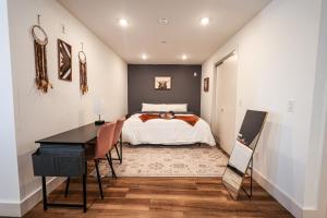 a bedroom with a bed and a desk at Studio Apartment - Inthephiladelphia in Philadelphia