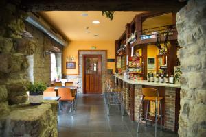 a restaurant with a bar and tables and chairs at Hotel Balcon de Aguera in San Martín