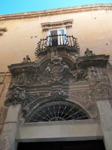 a building with a balcony on top of it at Appartamenti San Matteo in Lecce