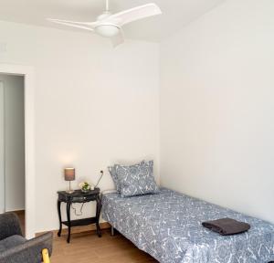 a bedroom with a bed and a table at Beach Villa Playa Flamenca in Orihuela Costa +21 photos