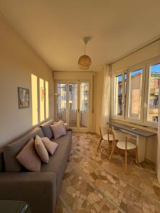 a living room with a couch and a table at Sally's - Nel cuore di Sanremo in Sanremo