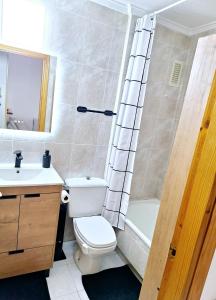 a bathroom with a toilet and a sink and a shower at Solymar Torrevieja in Torrevieja