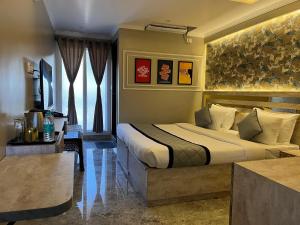 a hotel room with a large bed in a room at Hotel LG Signature Suites in Bangalore